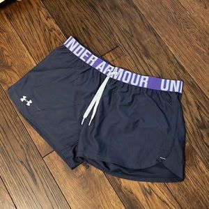 Under Armour nylon shorts. Dark gray with purple waist band. Worn very little